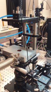 Cryogenic cell for luminescence research mounted under a microscope