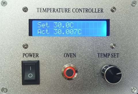 Front panel of the Ultra-Stable TEC Oven controller showing set and actual temperature on its LCD